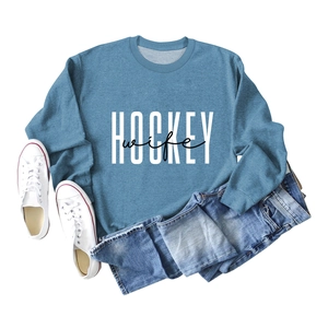 Flat lay of blue sweatshirt with Hockey Wife print paired with jeans and shoes
