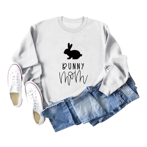 Flat lay of a white crew neck sweatshirt with Bunny Mom print and denim shorts