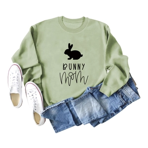 Sage green Bunny Mom graphic sweatshirt paired with blue jeans and white canvas shoes