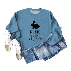 Flat lay of blue Bunny Mom sweatshirt with ribbed cuffs styled with denim shorts