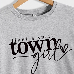 Light gray crewneck sweatshirt with 'just a small town girl' text and heart graphic