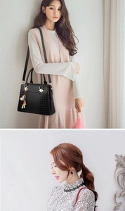 Détail du sac à main en cuir PU noir avec texture tissée et breloque à gland doré