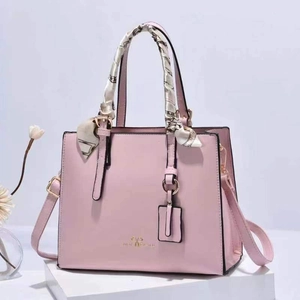 Pink PU leather tote bag with decorative scarf and gold hardware on white base