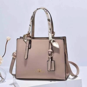 Elegant beige leather handbag with printed silk scarf wrap on handle and shoulder strap