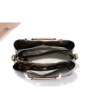 Top view of a structured handbag with multiple compartments and brown monogram pattern