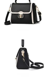 Détail du sac en cuir noir avec boucle dorée CP et bordure contrastée beige élégante