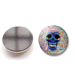 Front and back view of 25mm glass skull fridge magnet with colorful Mexican folk art