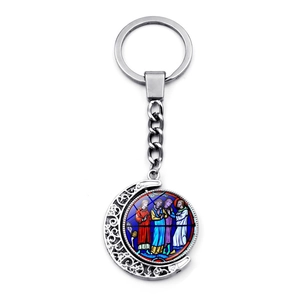 Detailed close-up of Notre Dame stained glass rotating moon keychain with silver metal finish