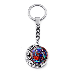 Detailed silver crescent moon keychain featuring intricate filigree and Notre Dame art