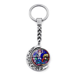 Detail of silver crescent moon keychain with Notre Dame stained glass art glass pendant
