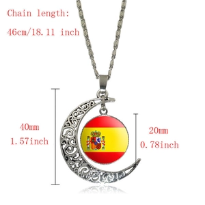Macro shot of silver hollow crescent moon pendant featuring the Spanish flag gem detail