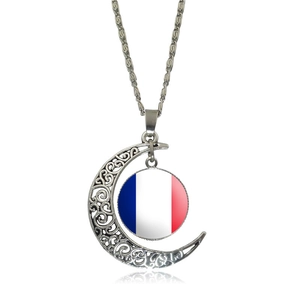 Detailed close-up of silver hollow moon pendant with French flag glass gem charm