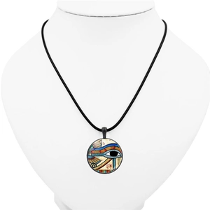 Detail of Egyptian Eye of Horus glass cabochon pendant with retro metal rim and black cord