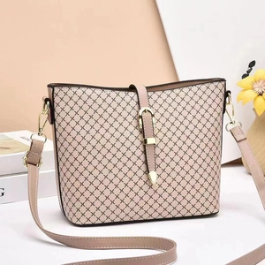 Minimalist beige textured bucket bag with geometric patterns and golden buckle detail