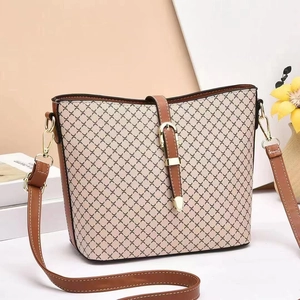 Chic cream canvas bucket bag with brown leather trim and cross-pattern texture