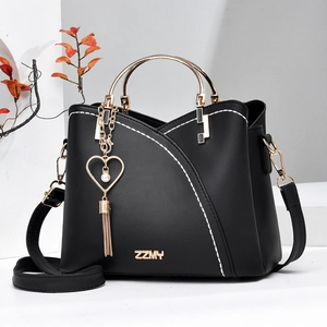 Fashionable black leather bucket bag with white stitching and gold metal handles