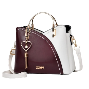 Burgundy and white bucket bag with gold circular handle and heart tassel detail