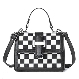 Chic black and white checkered crossbody bag with adjustable strap and top handle