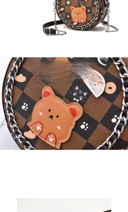 Detail of round crossbody bag with checkered pattern and cute cartoon animal patches
