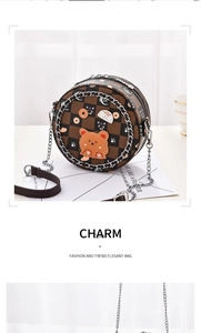 Detail of round crossbody bag featuring checkered pattern with cute cartoon patches