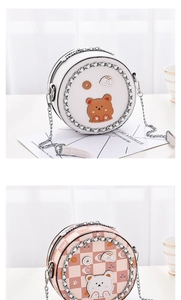Detail view of round mini crossbody bags with cute bear patches and metal chain straps