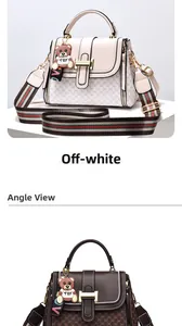 Detail view of two stylish crossbody bags with bear pendant and wide striped shoulder straps