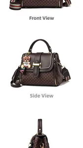 Detail view of brown monogram crossbody bag with wide stripe strap and bear charm