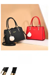 Detail of elegant wavy edge design on synthetic leather tote with white pompom charm
