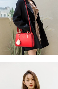 Detail of red tote bag with scalloped edges, golden hardware and white pompom charm
