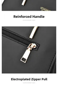 Detail of reinforced handle stitching and electroplated zipper on black leather handbag