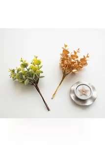 Artificial eucalyptus sprigs in matte gold and sage green for Christmas DIY decoration