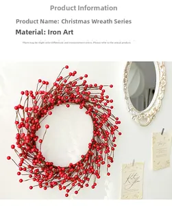 Detailed view of a Christmas red berry wreath on a white wall with vintage mirror décor