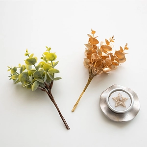 Artificial eucalyptus stems with gold star candle and silver holder for Christmas decor