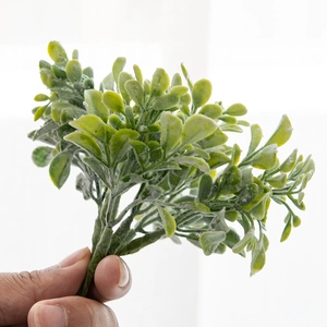 Artificial green pine branches with white frosty texture for Christmas DIY wreaths and decor