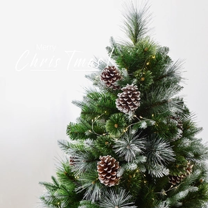 Artificial flocked Christmas tree with pine cones and warm LED lights on dense branches