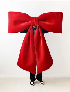 Extra large red velvet Christmas bow decoration for festive wall and space styling