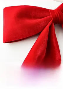 Close-up of high-quality red velvet fabric texture on a large decorative Christmas bow