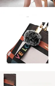 Close-up of a fluffy faux fur charm on a checkered tote bag with gold hardware detail