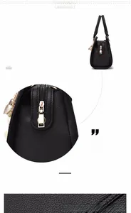 Detail of black PU leather handbag with cross-grain texture and secure metal zipper