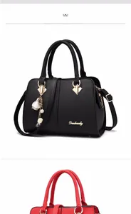 Detailed shot of black lychee grain handbag featuring gold hardware and flower pendant