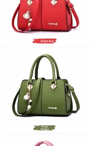 Detailed view of women's tote bags in red and green with litchi texture and metal pendant