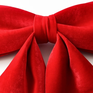 Oversized red velvet Christmas bow decoration for holiday parties and festive celebrations