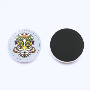 Close-up of circular sugar skull fridge magnets with colorful Mexican folk art patterns