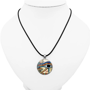Vintage Eye of Horus glass pendant necklace with a black cord on a white mannequin