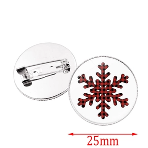 Detail of 25mm Christmas brooch featuring red plaid snowflake design and safety pin back