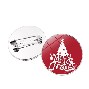 Detail of Christmas badge with festive red base and Merry Christmas tree design