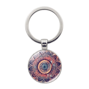 Macro detail of silver metal mandala keychain featuring colorful glass dome pattern