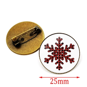 Detailed front and back view of a 25mm red buffalo plaid snowflake brooch pin