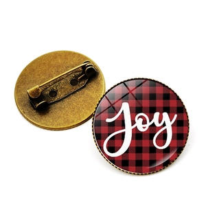 Dual view showing front Joy buffalo plaid badge and antique bronze pin back closure