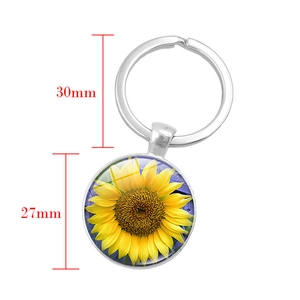 Sunflower glass dome keychain with silver ring and 27mm floral pendant on white background